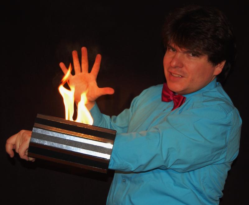 Magician Olivier OK MAGICS with burning arm